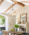 4 Light Farmhouse Candle Chandelier With Dope Open Orb Frame In Rustic White Finish hanging in a cozy dining room.