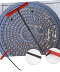 Badass Heavy Duty Steel Manhole Cover Lifter Hook Built With A Nifty T Handle on a storm drain cover for maintenance tasks.
