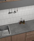 Kitchen countertop with 16x118 Inch Dark Grey Concrete Wallpaper Peel And Stick 3D Matte Textured Thick Cement Vinyl Wrap.