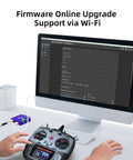 2.4GHz ER16 ELRS FPV 16CH Receiver setup with RC transmitter on desk near monitor showing firmware upgrade