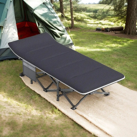 On The Go Camping Cot For Adults With Removable Cushion Lightweight Folding Bed That Packs In A Carry Bag Comfortable Tent Sleeping Cot Supports Up To 450 Lbs set up outside a tent on grass.