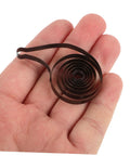 Steel Mainspring Clock Repair Kit For Mechanical Alarm Clocks 3 Pack Replacement Parts held in hand showing dark brown steel mainspring