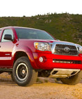 Red Toyota Tacoma with 7 Inch Spiral Flexible Rubber Antenna Replacement For Toyota Tundra And Tacoma 2000 2025 With Easy Install And Solid Reception For Your Everyday Driver on rugged terrain