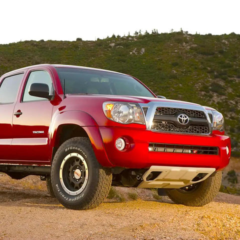 Red Toyota Tacoma with 7 Inch Spiral Flexible Rubber Antenna Replacement For Toyota Tundra And Tacoma 2000 2025 With Easy Install And Solid Reception For Your Everyday Driver on rugged terrain