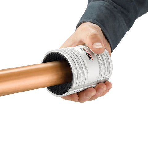 Ridgid 29993 227S chrome stainless pipe reamer tool, side view around copper pipe held in hand