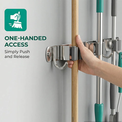 Hand using Stainless Steel Broom And Mop Wall Mount Organizer With Three Racks And Four Hooks Heavy Duty Space Saver Easy Install