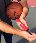 Man using All Sport Ball Maintenance Kit With 7.5 Inch Hand Pump And 3 Inflation Needles For Basketballs, Soccer Balls, Footballs, Volleyballs And More No Fuss Quick Inflation For Everyday Play on basketball
