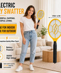Smiling woman holding Two Pack Handheld Bug Zapper Racket For Mosquitoes And Insects with 3000V High Voltage Electric Fly Swatter in living room.
