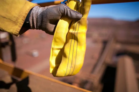Gloved hand holding 60mm Yellow Round Sling Endless Lifting Strap, Heavy Duty 6 Foot Rigging Sling For Construction Hoisting And Moving