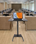 Premium Adjustable Height Standing Desk With Smooth Foot Pedal Operation And Fully Rolling Ergonomic Office Station in conference setting.