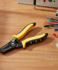 This awesome Self-Adjusting Wire Stripper And Cutter Is A Total Game Changer For Any Electrician Or Diy Pro on a workbench.