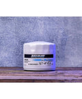 White spin-on oil filter for MerCruiser and GM Marine engines featuring MPleated media and anti-drain back valve on wood surface.