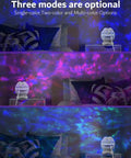 Dinosaur Eggs Galaxy Star Projector With Bluetooth Nebula LED Night Light in multicolor mode illuminating bedroom ceiling.