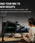 Person using Wave Mic Arm Studio Boom Arm For Streaming And Podcasting With Cable Channels Desk Clamp in home studio setup.