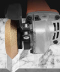 Pro-Grade Diamond Grinding Wheel For Marble And Granite, 20mm Bore, Bevel Edge V-Notch Profile, in use on stone surface