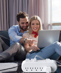 Couple using laptop with All In One Power Strip Surge Protector With USB C PD, 10 wide outlets, 6ft cord, on couch
