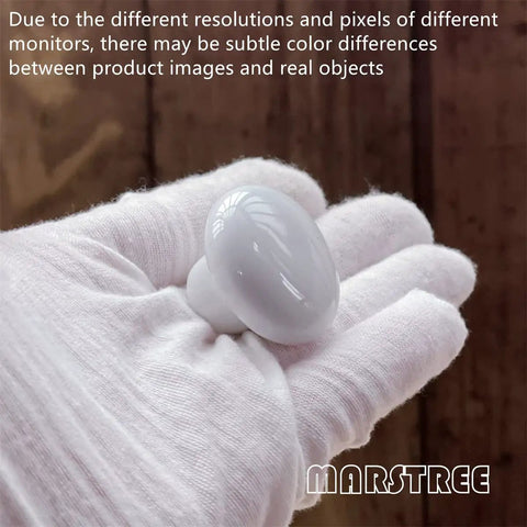 White Ceramic Round Kitchen Cabinet Knobs 10 Pack With Long And Short Screws displayed in a gloved hand