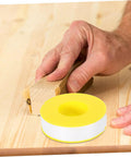 High Temp PTFE Sealing Tape Thread Sealant For Water Leaks on wooden surface with hand sanding background