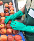 Heavy Duty Nitrile Glove Set, 15 Mil Chemical-Resistant, 13 Inch Gauntlet With Bisque Grip worn while handling apples