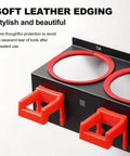 Close-up of spray bottle storage rack with two red hooks and soft leather edging for car detailing, showing black metal design.