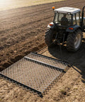 Tractor pulling a drag harrow for ATV and UTV, 4x5 foot chain harrow with rust resistant mesh, leveling soil in a field.