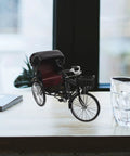 Absolutely Sweet Mini Motorcycle And Vintage Rickshaw Cake Topper With Detailed Metal Alloy Body set on a wooden table.