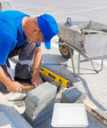 Man using DIY Concrete Molds For Walkways And Patios Easy To Use Square Flagstone Paver Casting Mold Durable Plastic Concrete Stamp
