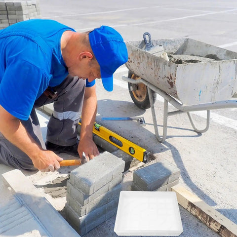 Man using DIY Concrete Molds For Walkways And Patios Easy To Use Square Flagstone Paver Casting Mold Durable Plastic Concrete Stamp
