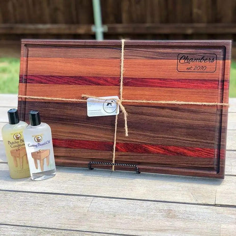 Heavy-Duty Go-To Butcher Block Conditioner And Cutting Board Oil, 12 Oz bottles next to wooden cutting board on table