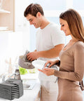 Couple in a kitchen using the Road Ready Felt Plate Organizer And Campervan Cabinet Game Changer, Knockout Eight Slot Dinnerware Holder In Clean Gray.