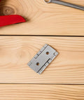 Vintage Iron Square Hinges Set For Furniture And Cabinets on wooden surface with wrench and red tool