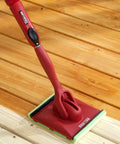Deck Stain Pad With Groove Tool For Even Coverage On Flat Surfaces And Between Boards shown with wooden deck and threaded handle