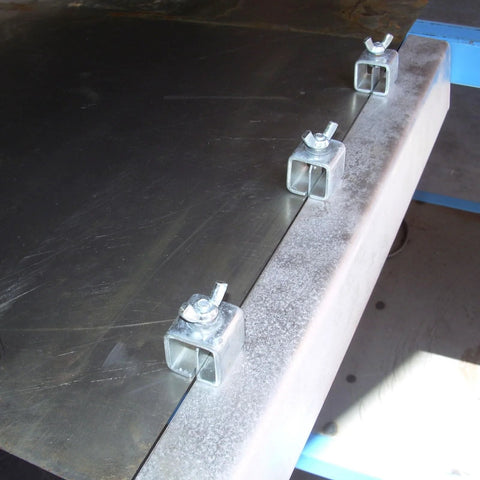 Acrux7 butt welding clamps, three small square-channel sheet metal panel clamps installed along a metal edge