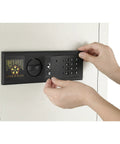 Person using LED keypad on an In Wall Safe For Home Or Biz With LED Keypad And Two Manual Override Keys Big Interior For Cash Jewelry Passports And More Discreet Hidden Safe You Can Access Fast And Easy