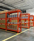 Heavy Duty Four Tier Steel Storage Rack Built To Handle Everyday Clutter For Garage Home Office Setup Quick Adjust Height Settings Heavy Gauge Metal Shelving Unit For Books Gear And Stash in warehouse with boxes stacked.