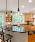Industrial Pendant Lighting Set with Clear Glass Shade installed over a kitchen island, showing adjustable cords and modern farmhouse style.