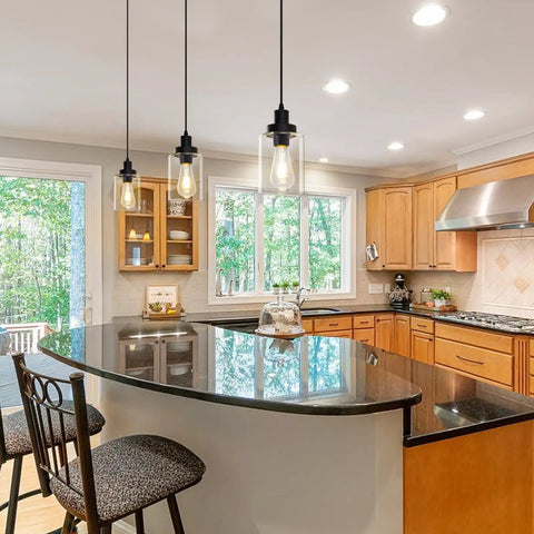 Industrial Pendant Lighting Set with Clear Glass Shade installed over a kitchen island, showing adjustable cords and modern farmhouse style.