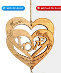 Wooden heart-shaped wall hanging with LOVE cutout and engraved script on natural wood finish