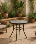 Glass top patio table on tiled veranda, surrounded by ferns and potted plants, illustrating use of 10 Pack Nylon Table Rim Clips.
