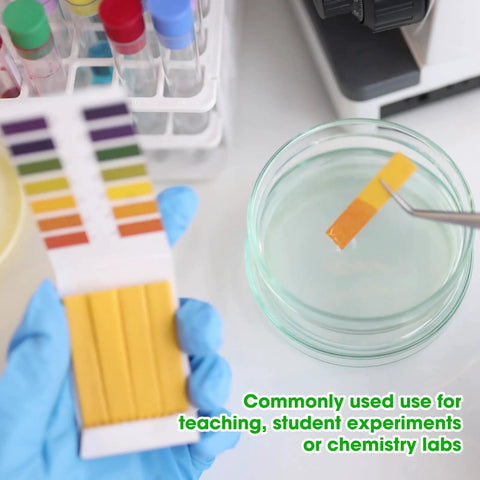 Gloved hand holding Ultimate 50 Pack pH Test Strips Kit 1 To 14 Universal Range, strip tested in petri dish, lab setting.