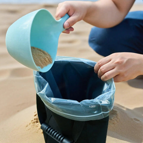 Filling Two Pack 45 Lbs Heavy Duty Umbrella Base Sand Bags with sand using scoop on beach