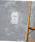 Hohopeti Heavy Duty Waterproof Electrical Junction Box for Outdoor Wiring mounted on wall near ladder for camera setup or garage.