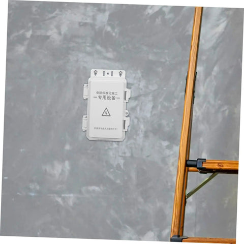 Hohopeti Heavy Duty Waterproof Electrical Junction Box for Outdoor Wiring mounted on wall near ladder for camera setup or garage.