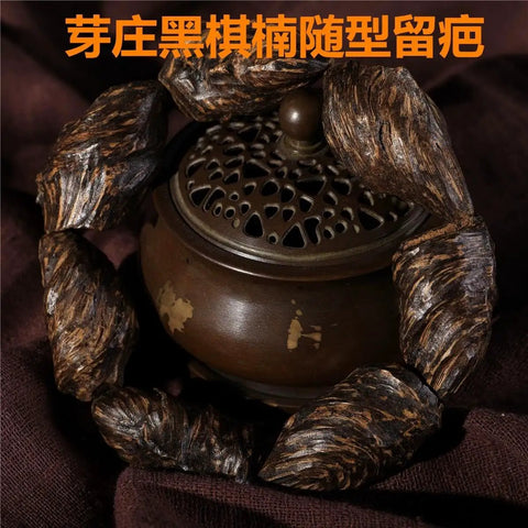 Vietnam Nha Trang Agarwood Unisex Jewelry burl scarred bracelet with black oil-aged appearance around incense holder.