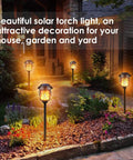 Solar Outdoor Torch Lights Set Of 4 Flickering Flame Metal Torches illuminating a garden with warm glow, dusk to dawn feature