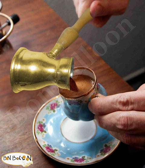 Old School Hand Hammered Solid Brass Copper Ibrik Pot Coffee Maker With Wooden Handle pouring coffee into cup