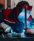 Welder using Three Style Aluminum Welding Coupon Set For One Point Five Inch Practice Plates, DIY Dice Shapes, Square And Triangle Coupons For TIG MIG Gas Arc Stick Welding Training, Beginner Friendly And Ready For Realistic Welding Practice, with dice-shaped aluminum pieces in front of him.
