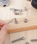 Person using All Purpose M5 304 Stainless Steel Screws Kit With 260 Pieces For 3D Printers And Furniture on wooden plank