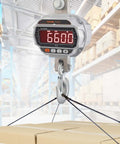 Digital Crane Scale 6600 Lbs 3000 Kg Heavy Duty Hanging Scale With Remote Control LED Display 5 Digit Readout 4 cm Tall Digits, shown weighing boxes in a warehouse.