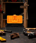 Rugged Multilayer Plastic Toolbox With A Secure Snap Latch And Spacious Yet Compact Shape on a workbench with tools.